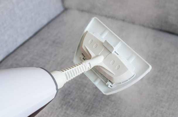 Cleaning fabric of the sofa with a steam cleaner. - Photo, Image