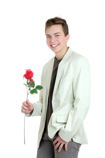 Valentin-nap. Holding a rózsa, mint a fehér háttér fiatalember portréja - Fotó, kép
