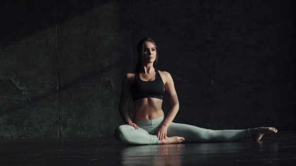 girl doing stretching sitting on a string. gymnast for training. attractive young woman in sportswear is engaged in yoga. - Footage, Video