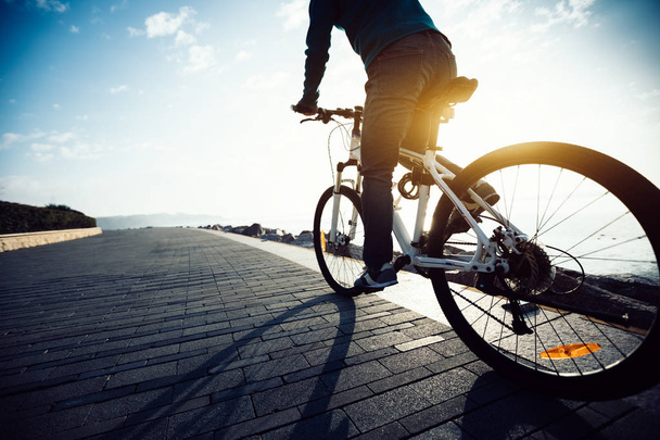 cyclist riding bike in seaside path during sunrise - Fotografie, Obrázek