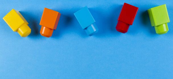 Colorful plastic construction blocks on blue background - Photo, Image