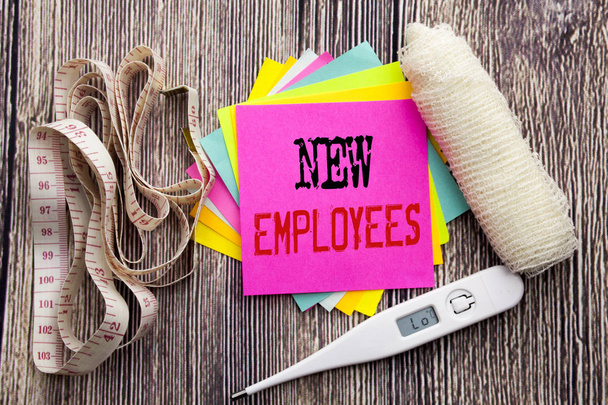 Handwriting Announcement text New Employees. Business fitness health concept for Welcome Staf Recruiting written sticky note empty paper background with bandage and thermometer   - Photo, Image