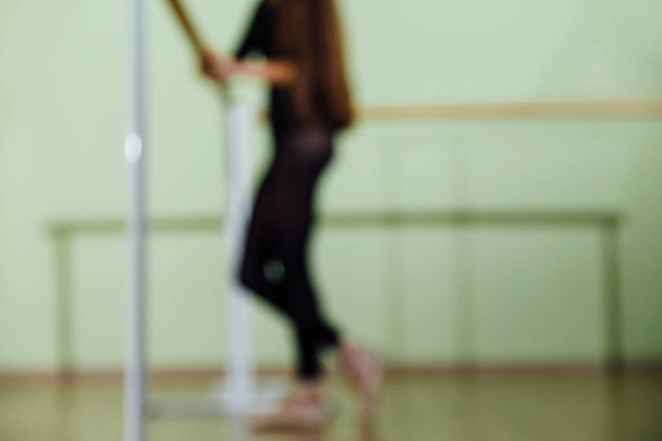 Elegant beautiful ballerina with a perfect body doing stretching exercise. - Φωτογραφία, εικόνα