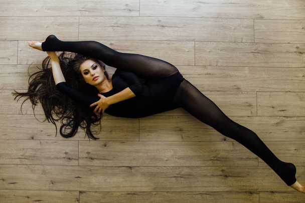 Beautiful young model ballet dancer lying inon floor. Top view. - Valokuva, kuva