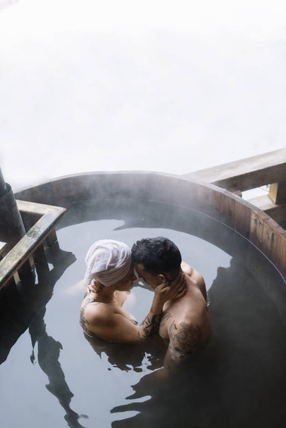 Young couple in hot spring - 写真・画像
