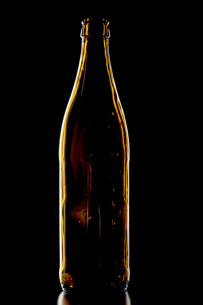 Empty beer bottle on black - Photo, image