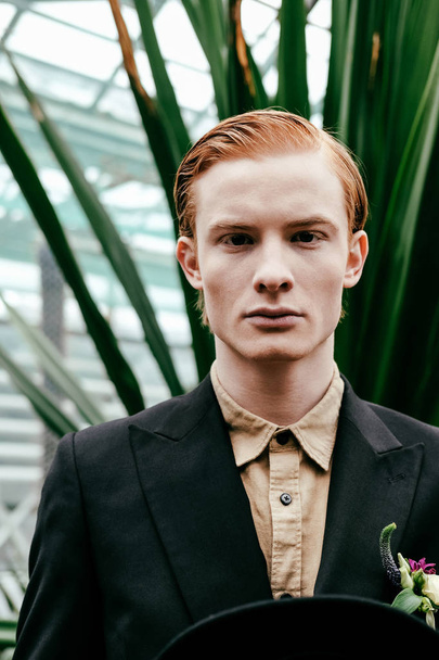 portrait of handsome red hair man in greenhouse - Foto, afbeelding