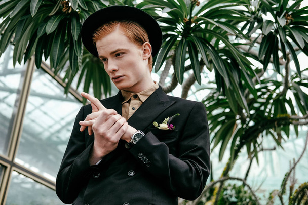 portrait of stylish young red hair man in hat in glasshouse   - Fotoğraf, Görsel
