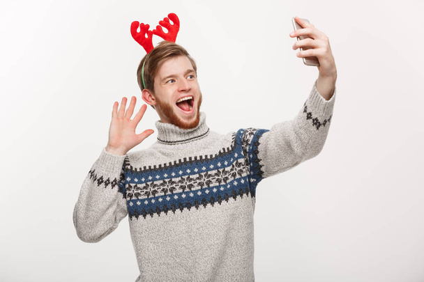 holiday and lifestyle concept - Young handsome beard man taking a selfie or talking facetime with friend. - Foto, Imagem
