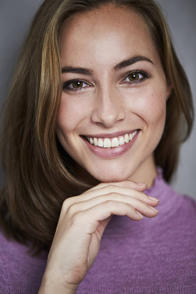 Portrait of brown eyed brunette smiling at camera - Fotó, kép