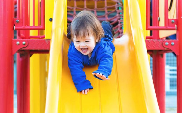 Toddler boy playing on the playground - Foto, imagen