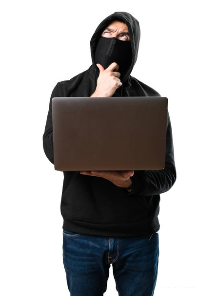 Hacker con su ordenador pensando en un fondo blanco aislado
 - Foto, imagen