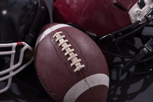 american football and helmets isolated on gray - Valokuva, kuva