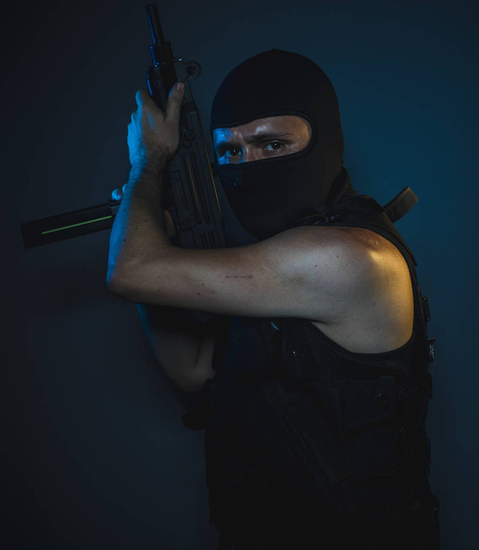 Bodyguard, hit man, armed and dangerous man with balaclava and bulletproof vest, concept killer contract - Fotografie, Obrázek