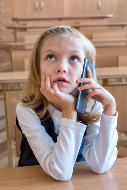 Uno studente di prima elementare parla per telefono. emozioni di studentesse
 - Foto, immagini