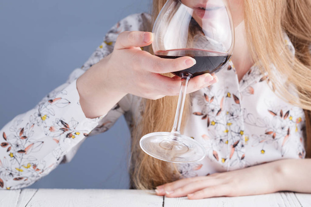 Beautiful young woman drinking red wine - Photo, image