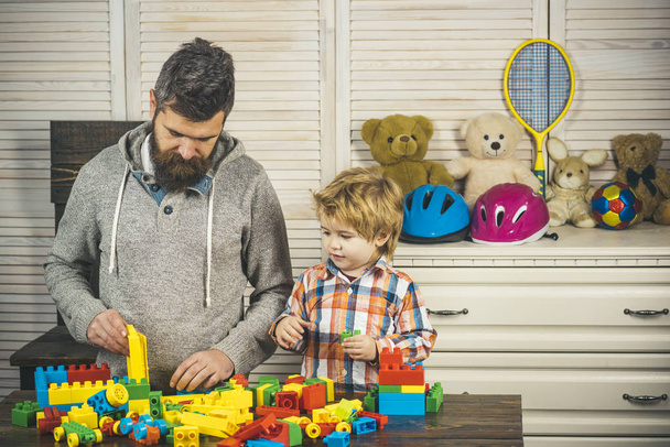 Family play with construction plastic blocks. Father and son play - Zdjęcie, obraz