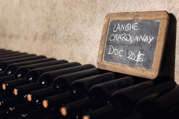 Langhe chardonnay bottles aging in a cellar - Photo, Image