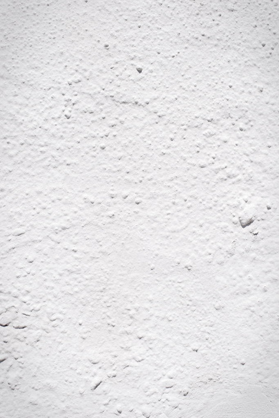 Background of a white stucco coated and painted exterior, rough cast of cement and concrete wall texture, decorative rustic coating - Fotografie, Obrázek