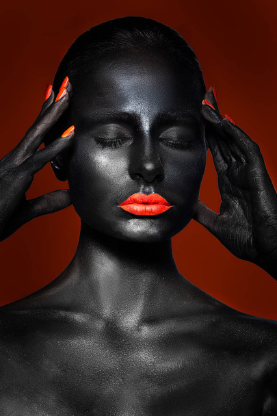 girl with black skin and red lips on a red background - Fotó, kép