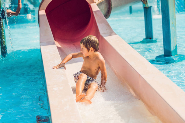 The boy is having fun in the water park. - Foto, Imagem