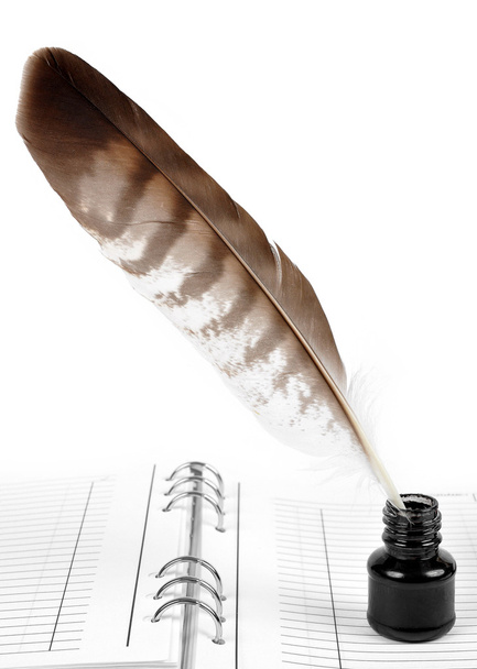 Feather with ink bottle and workbook - Photo, Image