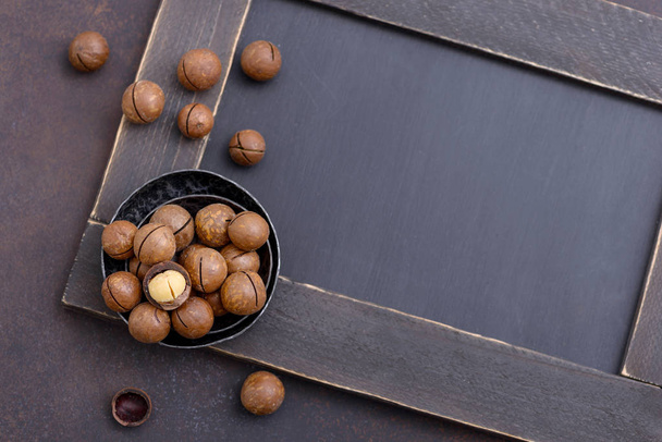 Macadamia nuts on dark background - Photo, Image