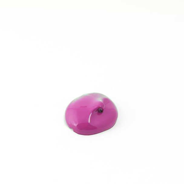 a drop of acrylic pink color on a white surface - Photo, Image