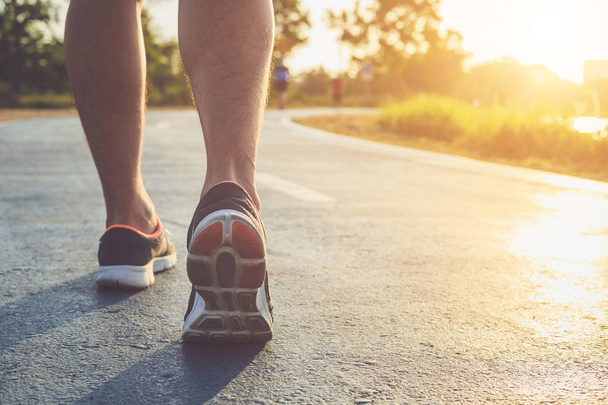 Man workout wellness concept : Runner feet with sneaker shoe run - Photo, Image