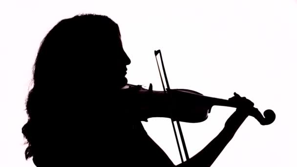 Isolated silhouette of a girl playing the violin. Black and white footage. - Footage, Video