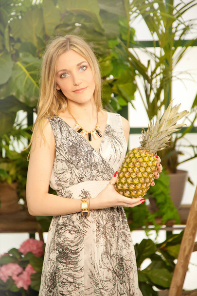 cute positive girl with pineapple - Foto, imagen