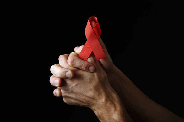 Aids ribbon on hands, hiv - Photo, Image