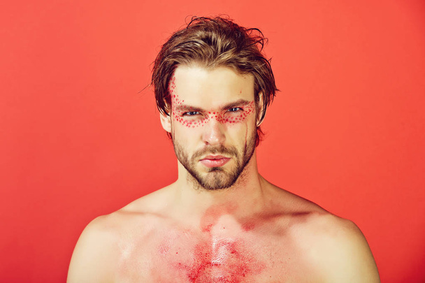man with creative fashionable makeup on red background - Фото, изображение