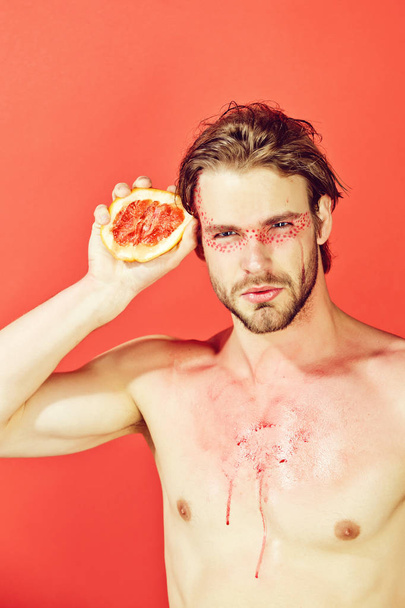 guy with creative fashionable makeup hold grapefruit, vitamin - 写真・画像