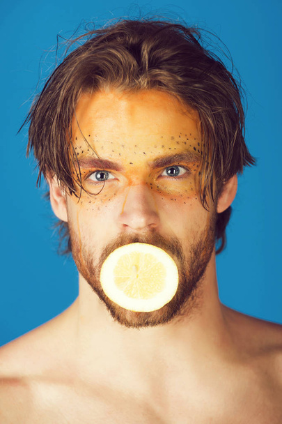 man with creative fashionable makeup hold lemon, vitamin - Foto, Imagen