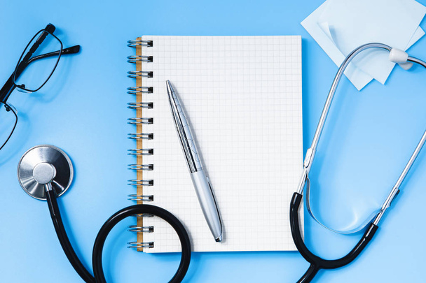 Stethoscoop op een blauwe tafel, concept van geneeskunde - Foto, afbeelding