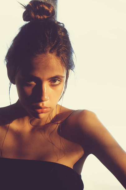 girl with bun and oily or wet face skin - Valokuva, kuva