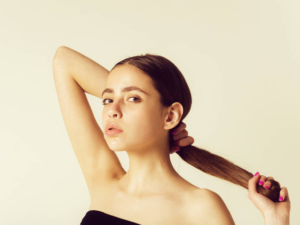 girl holding long, healthy, hair in hands - Фото, зображення