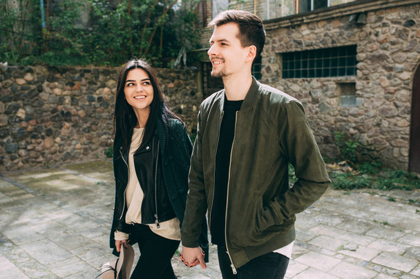Spring photo session of a beautiful young couple in the old courtyards of the city. - Fotó, kép