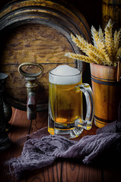 Light foam beer in a glass on an old background - Фото, изображение