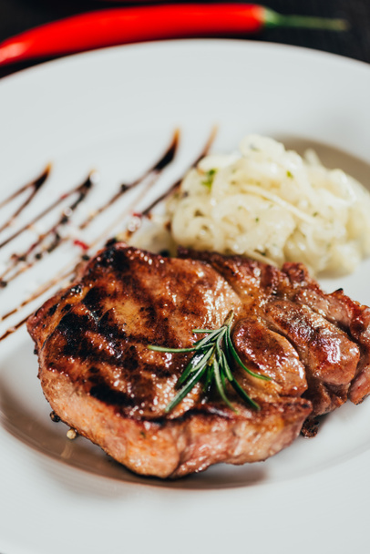close-up view of gourmet juicy grilled steak with rosemary on plate  - Foto, Imagem