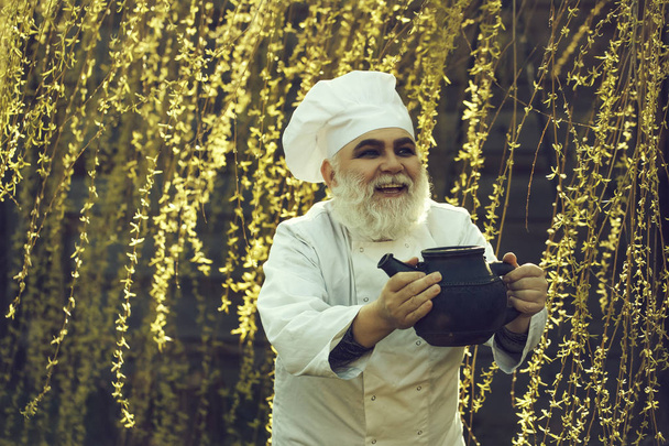 bearded cook with iron tea kettle - Photo, Image