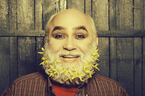 old man with flowers in beard - 写真・画像
