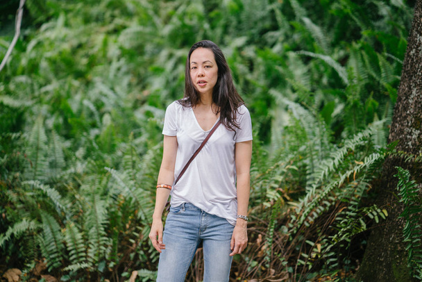 Portrait of a young Pan Asian woman in a park in the summer. - Foto, afbeelding