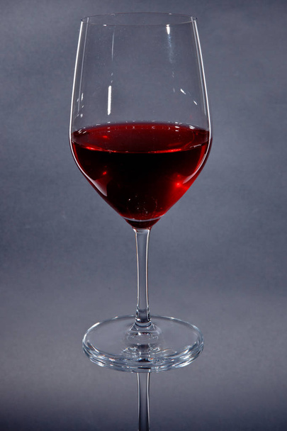 red wine glass isolated on gray - Фото, изображение