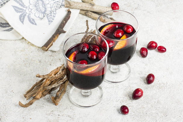 Warm mulled wine with citrus, cranberries  and spices with woode - Photo, Image