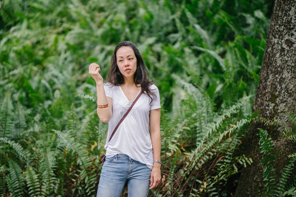Portrait of a young Pan Asian woman in a park in the summer. - 写真・画像