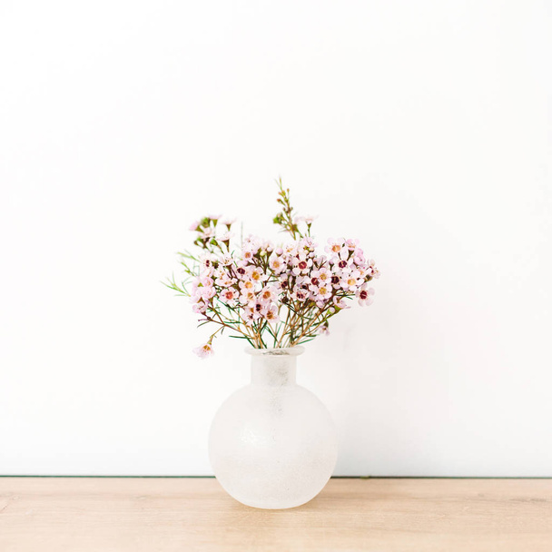 Wild flowers in vase on white background. Front view minimal composition. - Фото, зображення