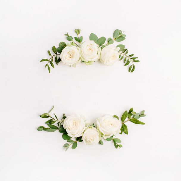 Floral καρέ στεφάνι λευκό τριαντάφυλλο μπουμπούκια ανθέων και ευκαλύπτου σε άσπρο φόντο. Επίπεδη lay, κορυφαία θέα κοροϊδεύω. - Φωτογραφία, εικόνα