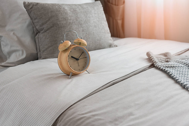 wooden modern alarm clock on bed - Photo, Image
